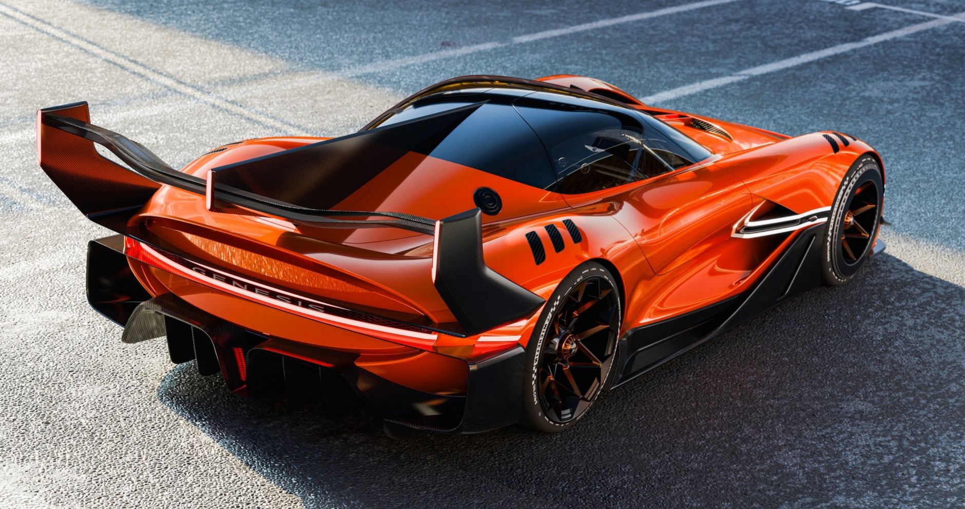 Stunning Genesis concept car showcasing sleek, futuristic design and luxury on an open road.