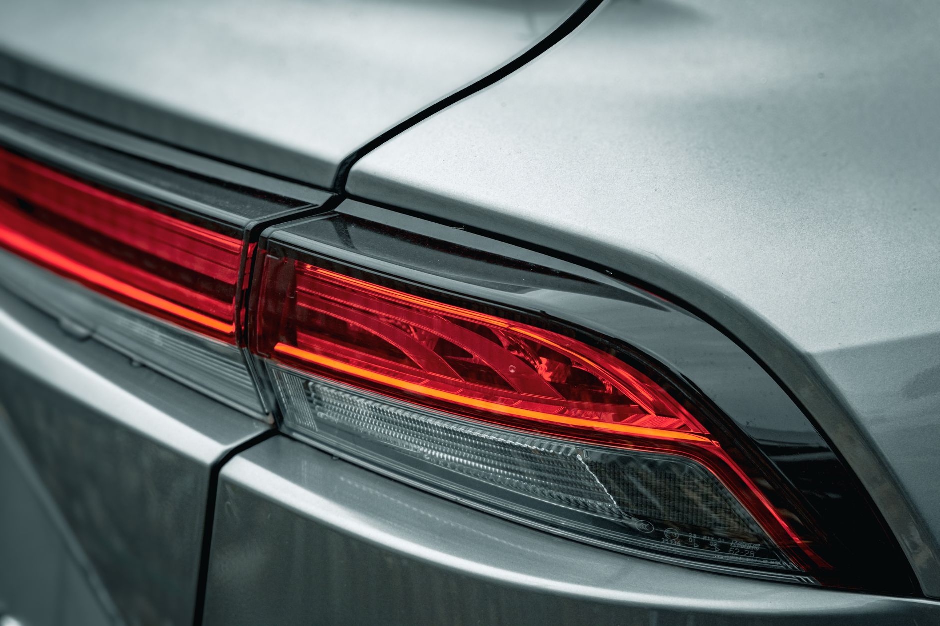 High-resolution image of a sleek modern car's taillight showcasing design details.