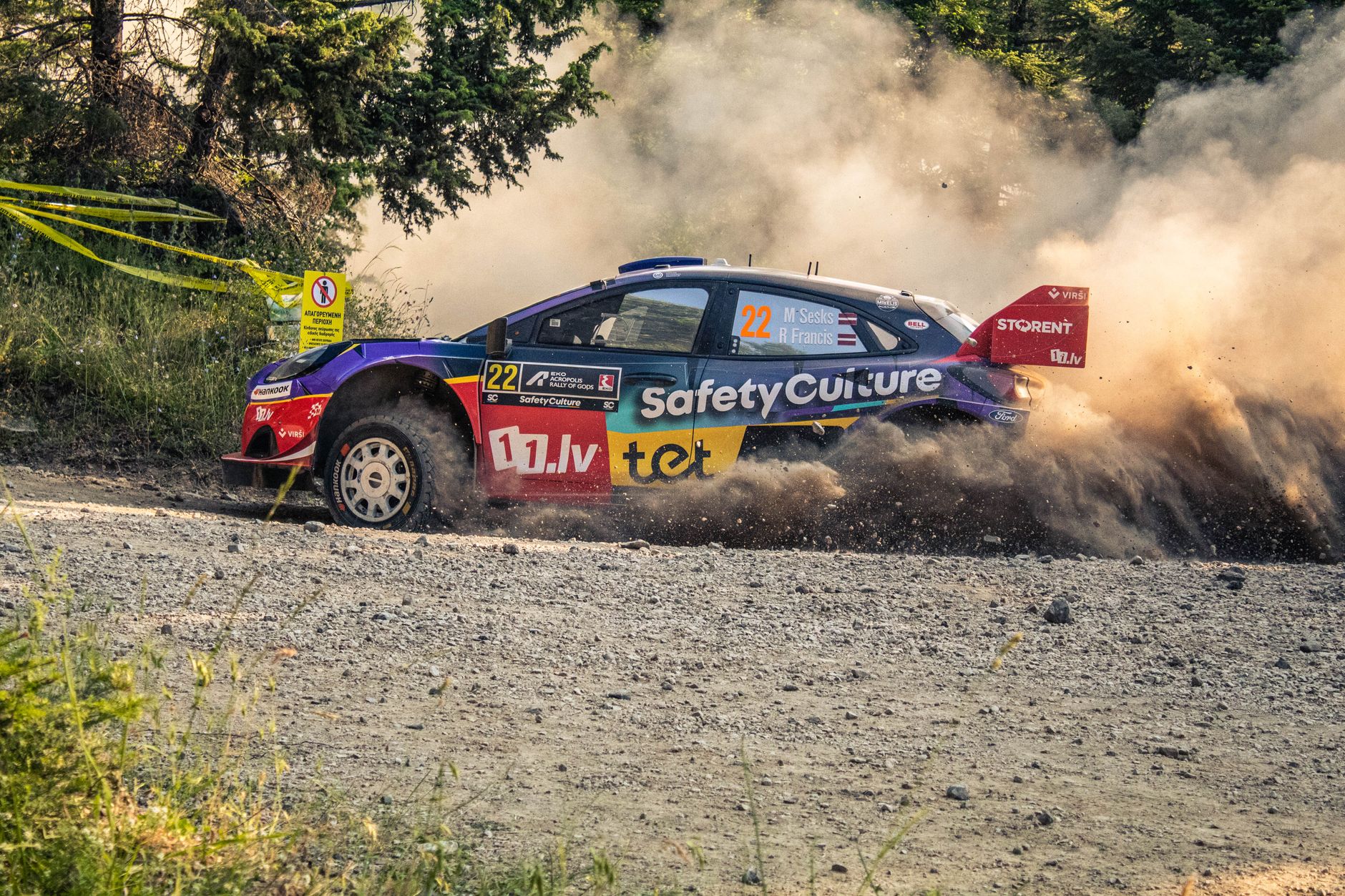 Exciting rally car racing through dust on a gravel road in Pavliani, Greece.