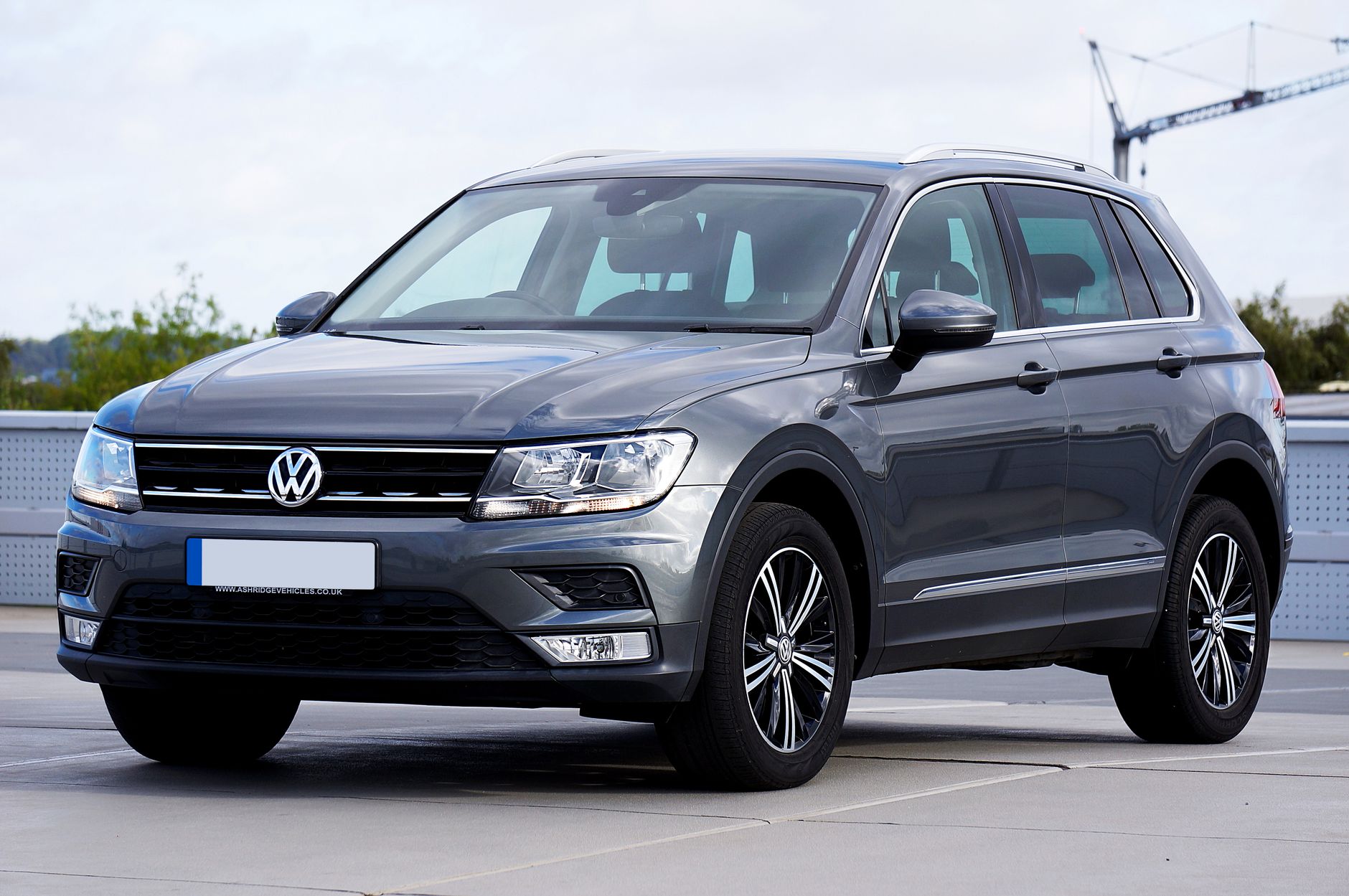 Stylish gray Volkswagen Tiguan SUV parked in an urban outdoor setting during the day.