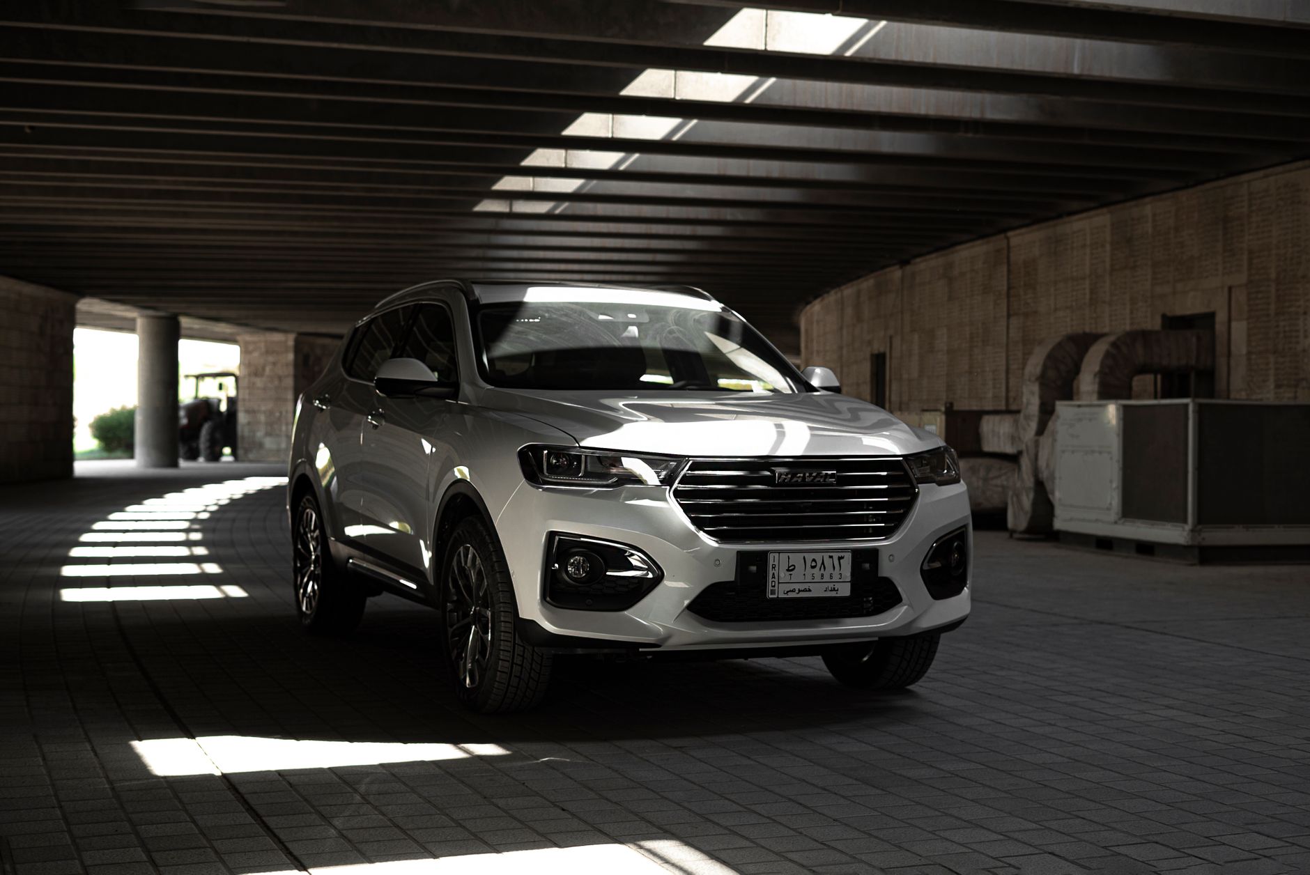 Sleek white SUV parked in a modern urban environment, emphasizing style and design.