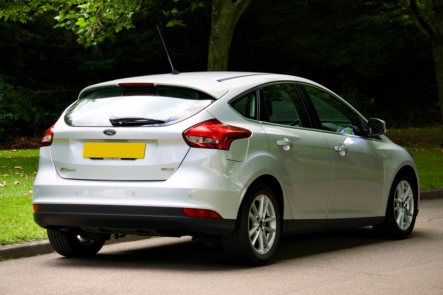 Silver Ford Focus hatchback parked outdoors on a sunny day, showcasing its sleek design.