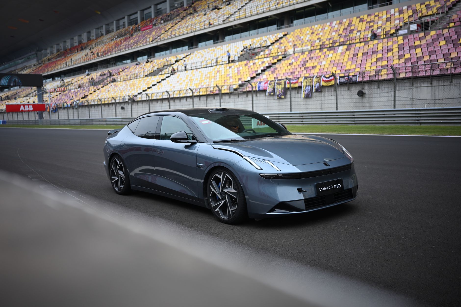 Stylish modern car parked on an empty Shanghai racetrack during the day.