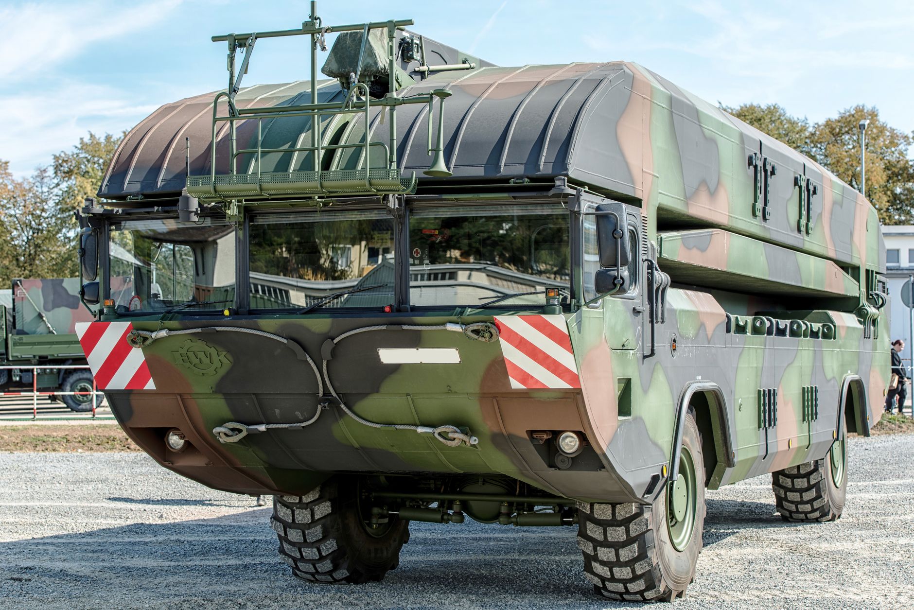 Front view of a camouflage military vehicle displayed outdoors in Hamburg, Germany.