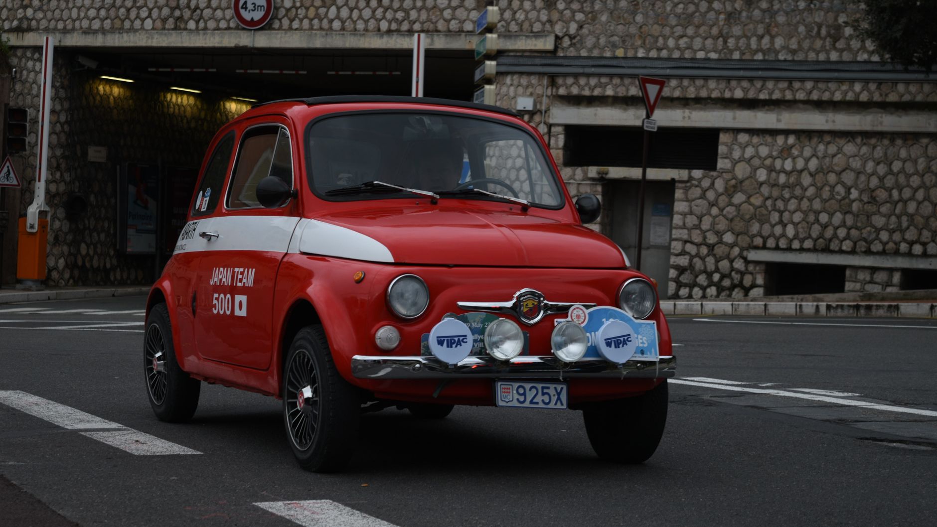 Classic red Fiat 500 car parked on a street in Nice, France.