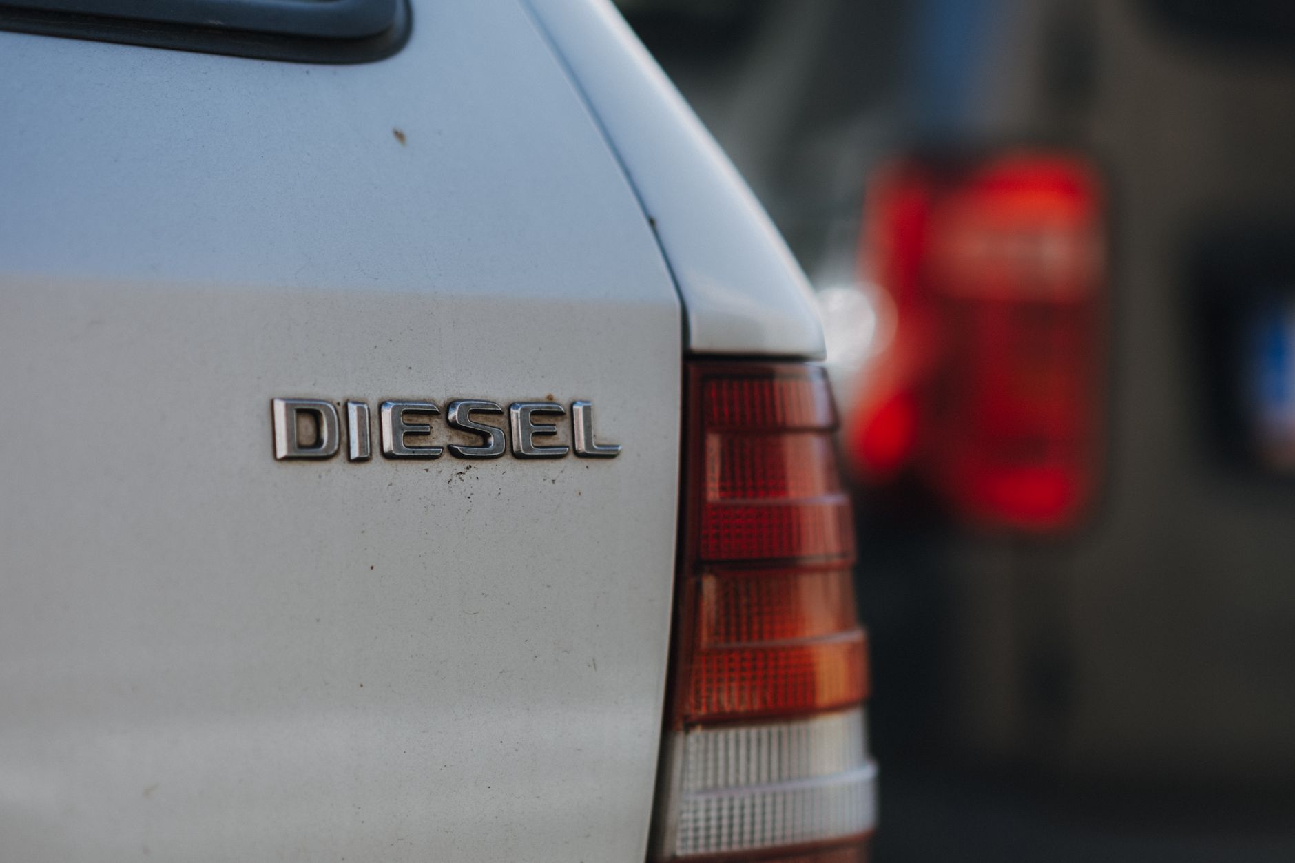 Detailed view of a diesel car badge with blurred background, captured in Prague.