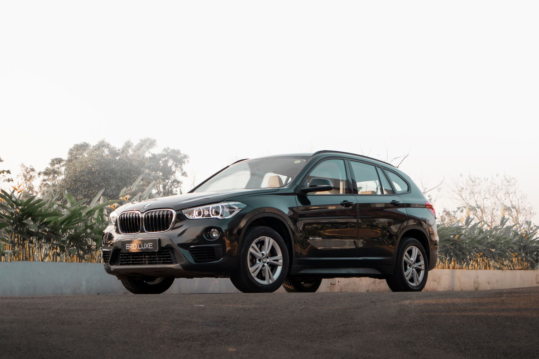 Stunning black BMW X1 SUV parked outdoors, showcasing sleek design and elegance.