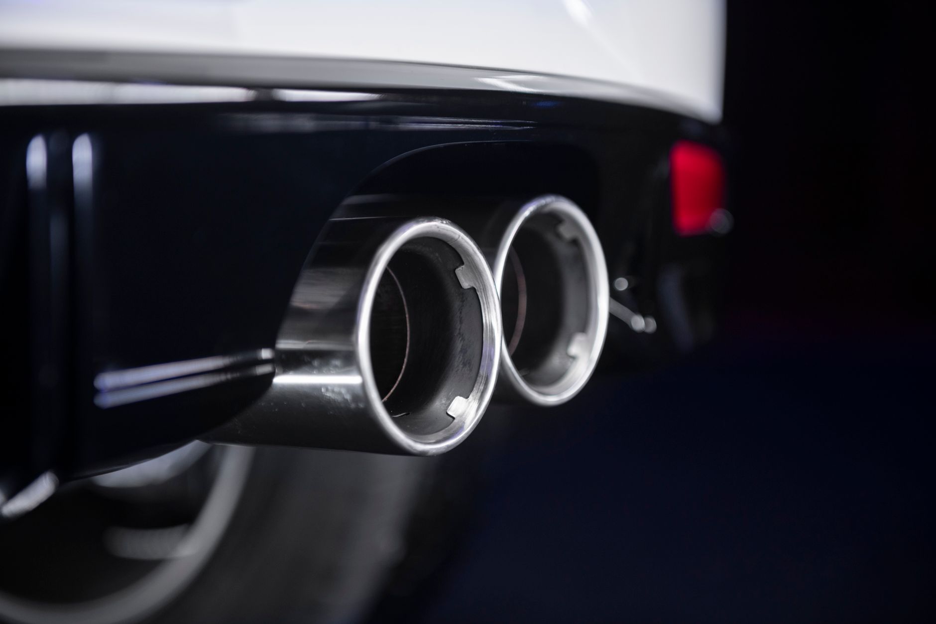 Detailed view of a chrome twin exhaust on a modern vehicle.