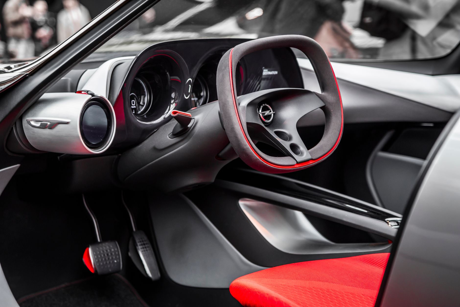Explore this sleek car interior showcasing a futuristic steering wheel and dashboard design.